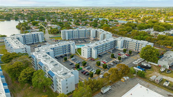Aerial view of a large apartment complex with multiple buildings and surrounding residential area.