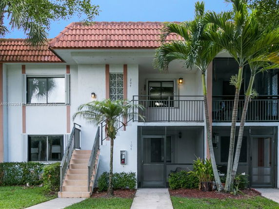 Front view of a two-story residential building with a tile roof.