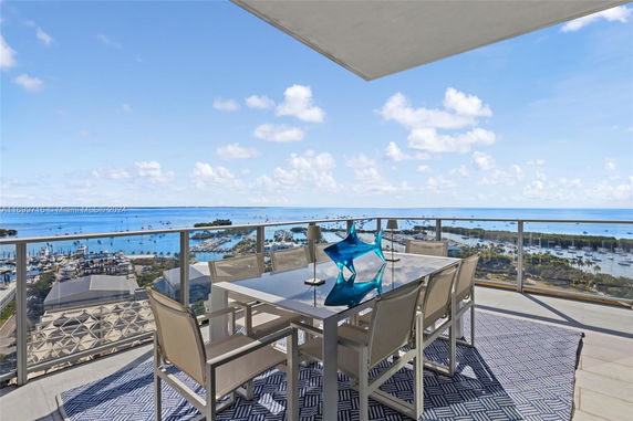 Panoramic view from a balcony overlooking a harbor and sea.