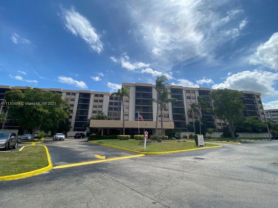 Front view of a multi-story apartment building with a central entrance.