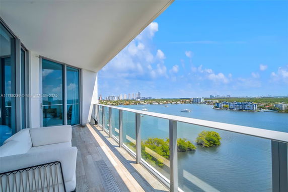 View from a balcony overlooking a water body and distant cityscape.