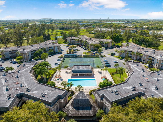 Panoramic view of a residential complex with surrounding landscape.