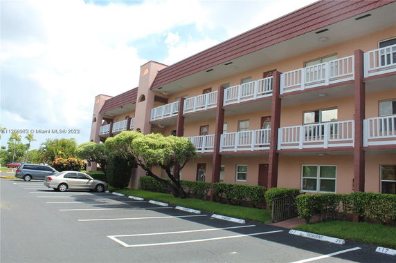 Front view of a three-story building with multiple balconies.