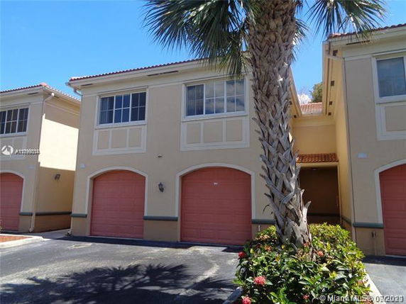 Front view of a two-story building with double garage doors.