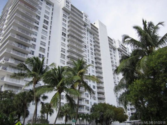 Front view of a multi-story apartment building with balconies.