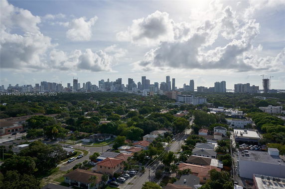 Wide angle view of a city skyline with residential and commercial buildings.