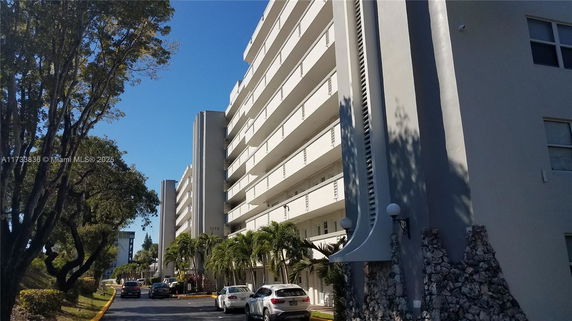 Front view of a multi-story building with balconies.