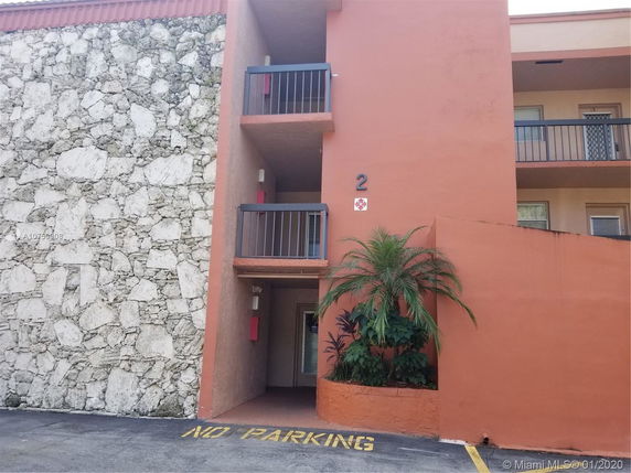 Front view of a building with stone and orange painted exterior walls.