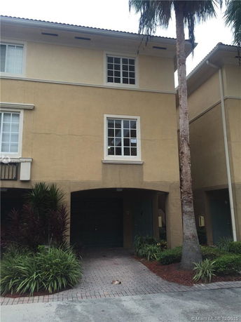 Front view of a multi-story house with a garage.