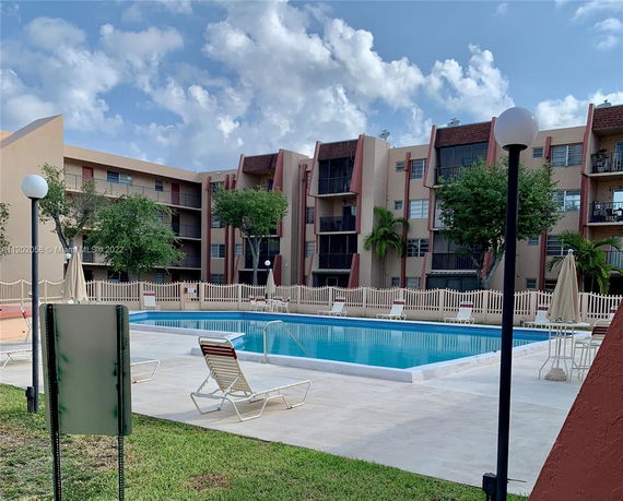 Residential building with a swimming pool in the foreground.