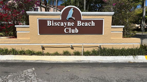 Signage of Biscayne Beach Club outside a building complex.