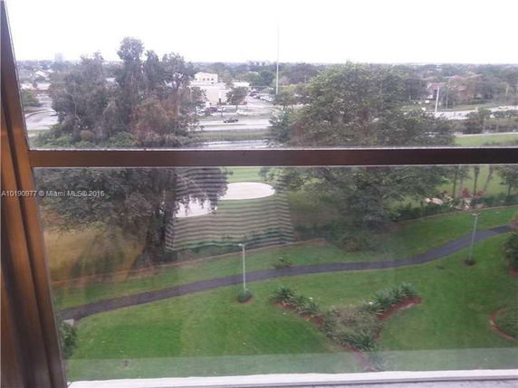 View from a building showing surrounding areas with trees and pathways.