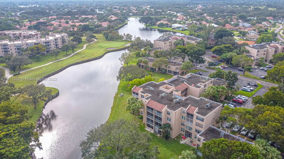 Aerial view of a residential area with multiple apartment buildings near a river.