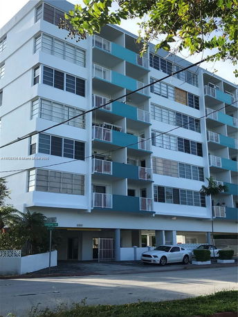 Front view of a multi-story residential building with balconies.