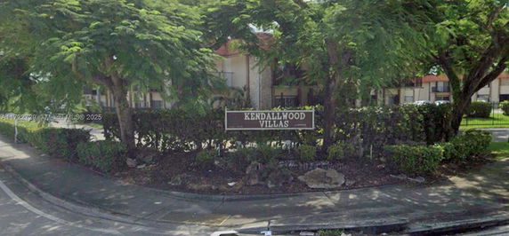 Front view of Kendallwood Villas with trees and shrubs.