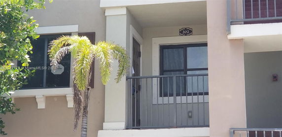 Front entrance of a residential building with a balcony