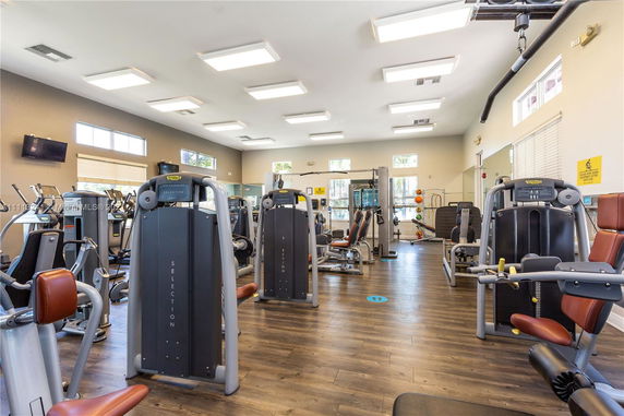 Interior view of a gym with various exercise machines and equipment.