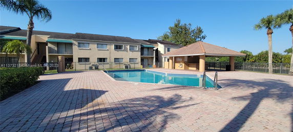 Outdoor area with a swimming pool and adjacent building.