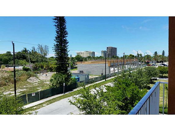 View of surrounding areas with trees and buildings in the distance.