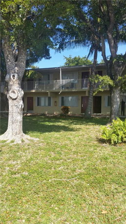 Front view of a two-story building with balconies.