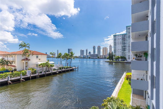 Panoramic view of a waterway with modern high-rise buildings in the background.