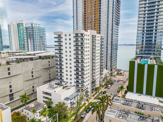Aerial view of several high-rise buildings near a body of water.