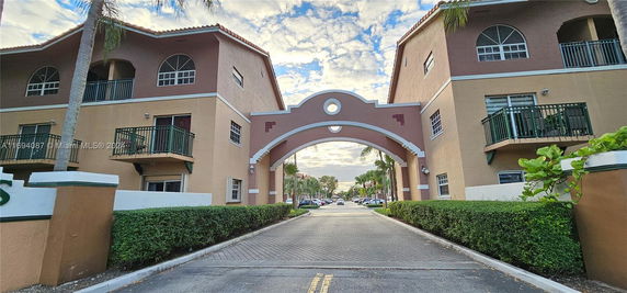 Front view of a two-story residential building with an archway entrance.