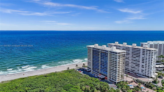 High-angle view of a beachfront building adjacent to the ocean.