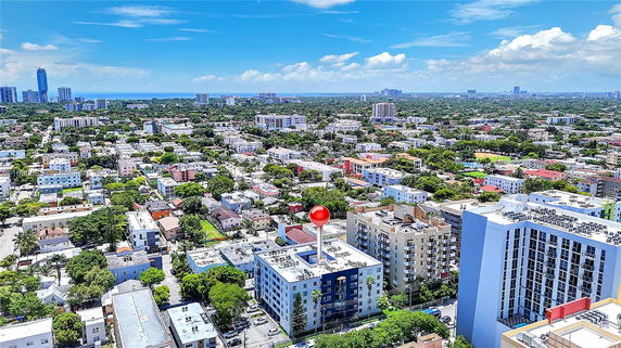 Panoramic view of a cityscape with residential and commercial buildings.