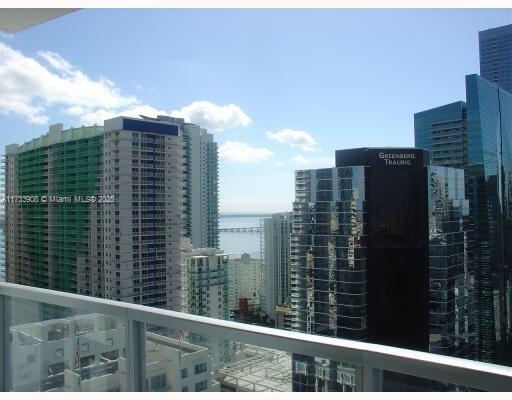 Panoramic view of high-rise buildings and skyline with ocean in the background.