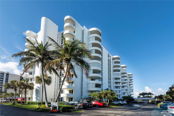 Front view of a multistory residential building with curved balconies.