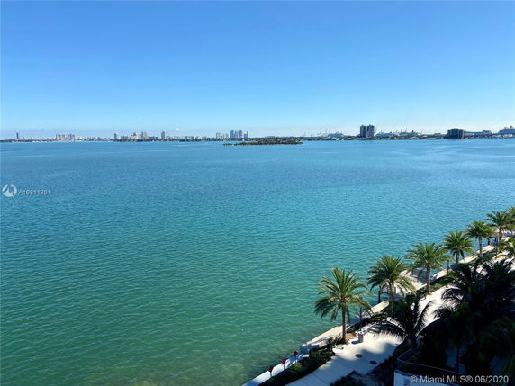 Wide view of a large body of water with city skyline in the distance.