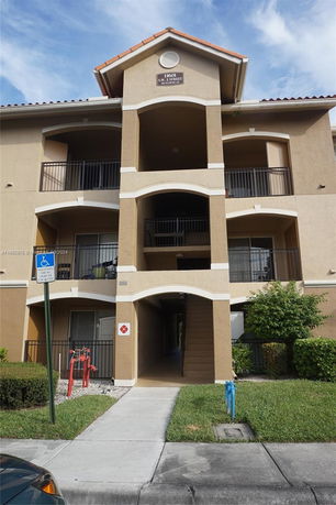 Front view of a multi-story residential building with balconies.
