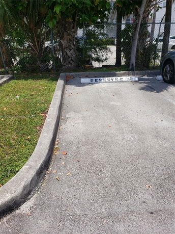 Outdoor parking space with a reserved sign.