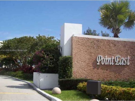 Front view of an entrance sign for a residential area labeled 'Point East'.
