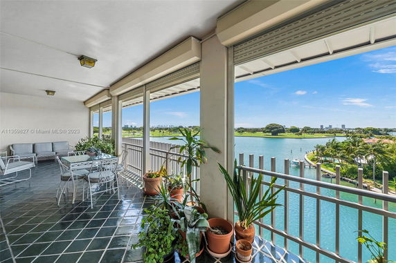 Panoramic view from a balcony overlooking a body of water and greenery.