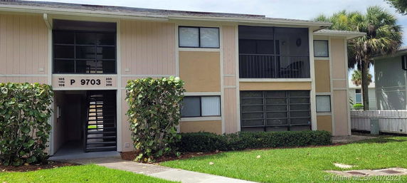 Front view of a two-story apartment building with balconies.