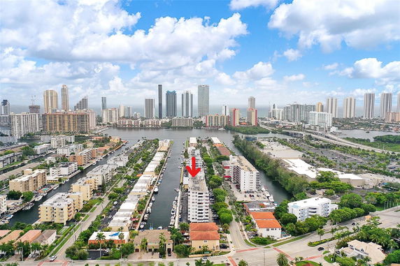 Aerial panoramic view of urban landscape with multiple high-rise buildings and waterways.