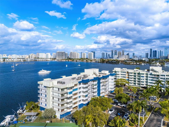 View of waterfront buildings with a city skyline in the background.