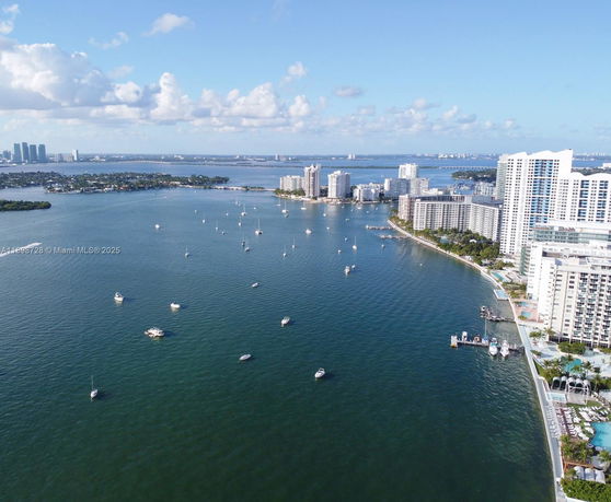 Panoramic view of waterfront buildings with boats in the water.