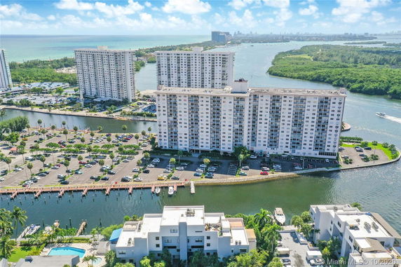 Aerial view of multiple high-rise buildings near a waterway.