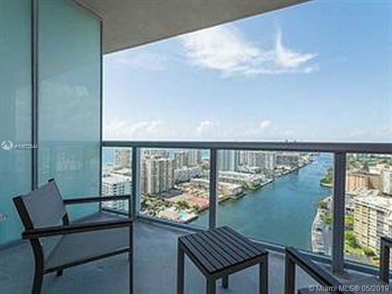 Balcony view overlooking a river and cityscape.