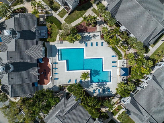 Aerial view of a large outdoor swimming pool surrounded by residential buildings.