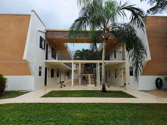 Front view of a two-story building with exterior stairs and balconies.