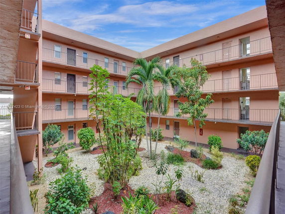 Interior courtyard of an apartment complex with landscaped garden area.