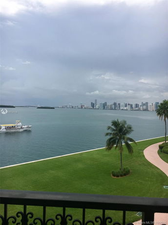 Panoramic view of a waterfront area with a city skyline in the distance.