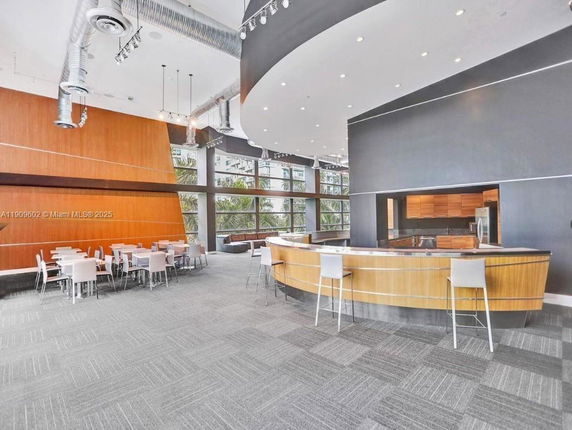 Interior view of a modern club house with seating area and bar.