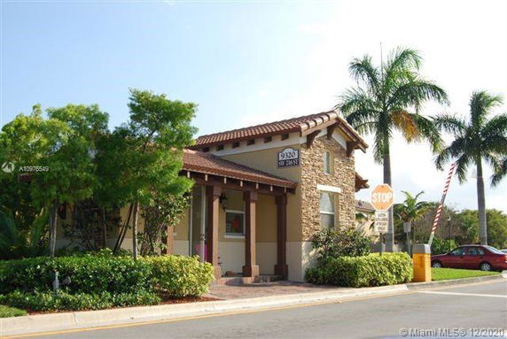 Front view of a single-story house with a tiled roof and stone facade.