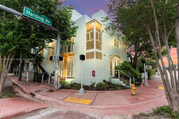 Front view of a modern two-story building at a street corner.