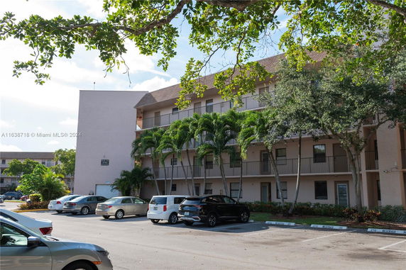 Outdoor parking area in front of a multi-story building.